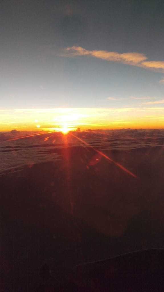 Picture of the sun setting from an airplane window