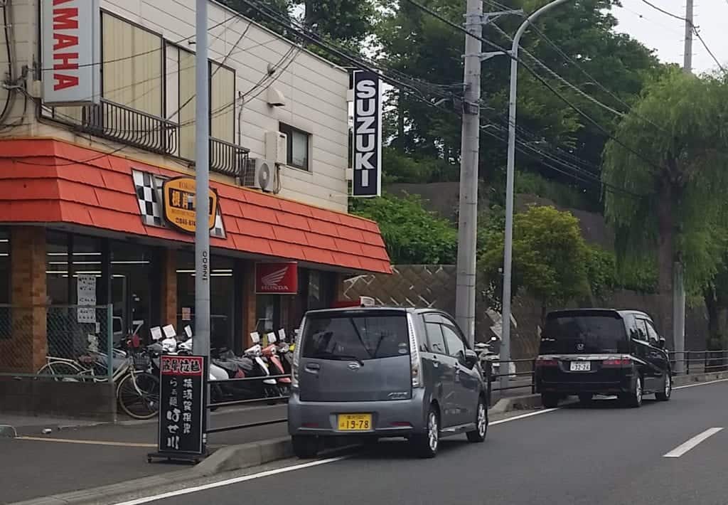 Cars illegally parked on the side of the road in Japan