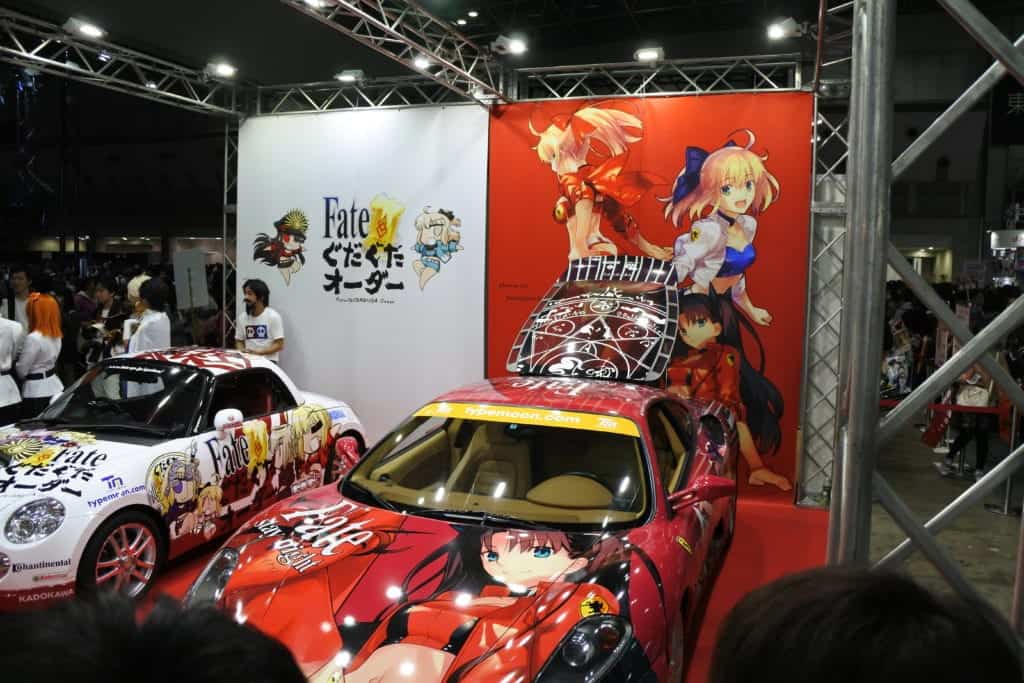 Cars decked out with characters from the Fate series.