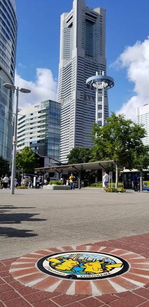 Landmark Tower with a Pokemon manhole cover in the foreground