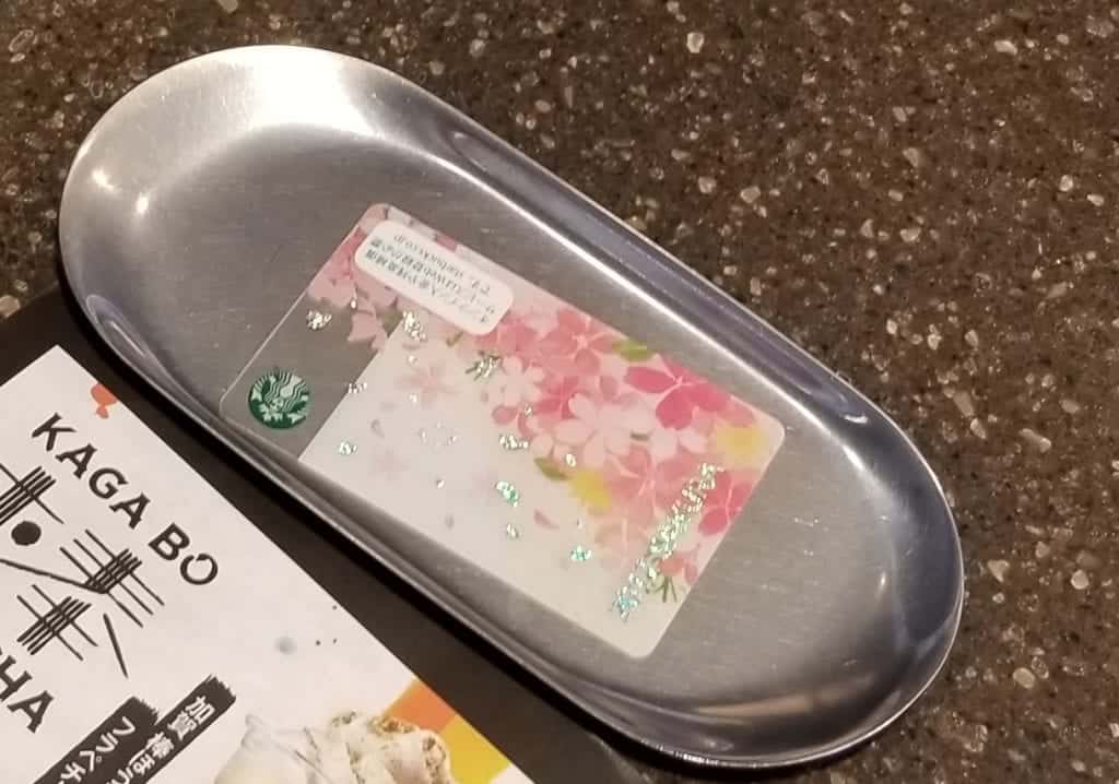 Cash Tray used for paying in Japan with a Starbucks Japan card on it