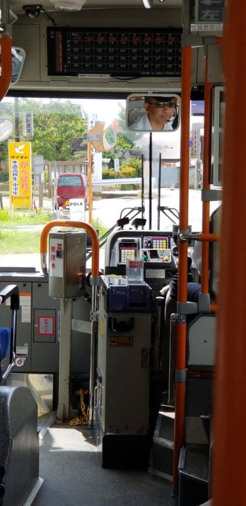 Buses in Japan have a console at the front to pay with either cash or sometimes an IC Card