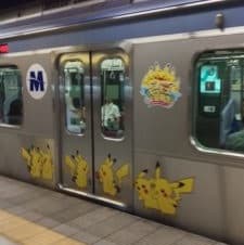 A blue line train in Yokohama covered with Pikachu character designs for the Pikachu Outbreak Festival