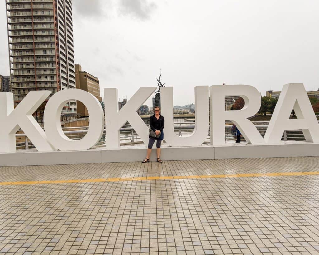 Kokura Sign with Kristen Abroad creator standing in front